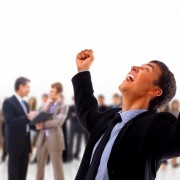 One very happy energetic businessman with his arms raised