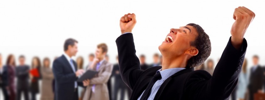 One very happy energetic businessman with his arms raised